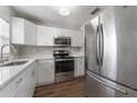 Modern white kitchen with stainless steel appliances at 10206 Lola St, Tampa, FL 33612
