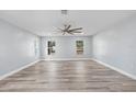 Spacious living room features wood-look vinyl flooring and a ceiling fan at 1179 Huntington Ave, Spring Hill, FL 34609