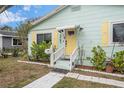 House exterior featuring a yellow door and landscaped front yard at 1701 32Nd N Ave, St Petersburg, FL 33713