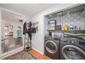 Bright laundry room with washer, dryer, and storage shelves at 1701 32Nd N Ave, St Petersburg, FL 33713