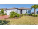 Exterior view of a single story house with a brick driveway at 19494 Sea Glass Cir, Land O Lakes, FL 34638