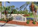 Elegant community sign for La Puerta Del Sol, framed by palm trees and lush landscaping at 5642 Puerta Del Sol S Blvd # 242, St Petersburg, FL 33715