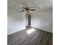 Bright bedroom with ceiling fan and grey vinyl flooring at 7304 Dianne Dr, New Port Richey, FL 34652