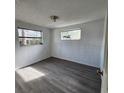 Simple bedroom with grey vinyl flooring and a window at 7304 Dianne Dr, New Port Richey, FL 34652