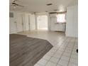 Open living area with grey vinyl and tile flooring at 7304 Dianne Dr, New Port Richey, FL 34652