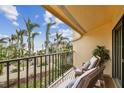 Private balcony overlooking the ocean and palm trees at 7550 Sunshine Skyway S Ln # T48, St Petersburg, FL 33711