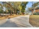 Home's exterior showcasing a long driveway leading to the house at 9402 Forest Hills Cir, Tampa, FL 33612