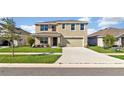 Two-story house with a two-car garage and a landscaped front yard at 16743 Carlton Pond St, Wimauma, FL 33598