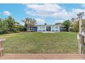 Spacious backyard with a canal view and a dock at 911 Silver Palm Way, Apollo Beach, FL 33572