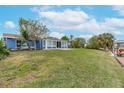 Large grassy backyard with a view of the canal at 911 Silver Palm Way, Apollo Beach, FL 33572