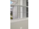 Close-up of a multi-paned window, showcasing the exterior view at 12318 Hearts Ease St, Venice, FL 34293