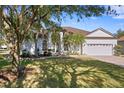 House exterior showcasing a manicured lawn and mature oak trees at 16310 Ashington Park Dr, Tampa, FL 33647