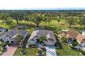 Bird's eye view of a home with a pool, and golf course in background at 324 Caloosa Palms Ct, Sun City Center, FL 33573