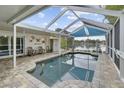 Relaxing pool area with covered patio overlooking lake at 12038 Steppingstone Blvd, Tampa, FL 33635
