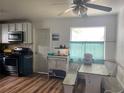 Eat-in kitchen features wood flooring, an oven, microwave, and built-in breakfast nook at 2716 49Th S St, Gulfport, FL 33707