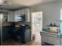 Traditional kitchen with white upper cabinets and a breakfast nook off the side at 2716 49Th S St, Gulfport, FL 33707