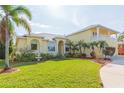 Two-story house with a landscaped lawn, palm trees, and a two-car garage at 924 Bunker View Dr, Apollo Beach, FL 33572