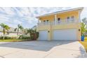 Two-story house with a large driveway, two-car garage, and balcony at 924 Bunker View Dr, Apollo Beach, FL 33572