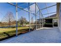 Spacious screened-in porch overlooking a grassy backyard at 3152 Banyan Hill Ln, Land O Lakes, FL 34639
