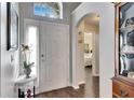 Bright and spacious entryway with hardwood floors and an archway at 31935 Brookstone Dr, Wesley Chapel, FL 33545
