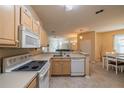 Spacious kitchen with light wood cabinets, appliances, and breakfast bar at 2003 Acadia Greens Dr, Sun City Center, FL 33573