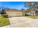 Two-story house with a three-car garage and neatly landscaped yard at 18214 Stillwell Ln, Tampa, FL 33647
