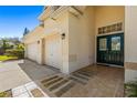 Front entry with double doors and a three-car garage at 18214 Stillwell Ln, Tampa, FL 33647