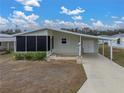 Mobile home with carport and landscaped yard at 3907 William Hume Dr, Zephyrhills, FL 33541