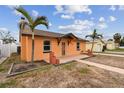 House exterior with walkway and palm trees at 440 77Th Ave, St Pete Beach, FL 33706