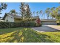 House exterior showcasing a two-car garage and manicured lawn at 5474 Kemkerry Rd, Wesley Chapel, FL 33543