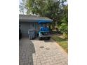 Attached garage with golf cart and paved driveway at 5474 Kemkerry Rd, Wesley Chapel, FL 33543