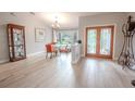 Bright dining room with hardwood floors and access to the front entry at 1000 Chillum Ct, Safety Harbor, FL 34695