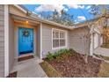 Charming light blue front door with a wreath and walkway at 2409 Arborwood Dr, Valrico, FL 33596