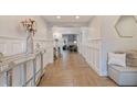 Bright and airy foyer with herringbone floors and wainscoting at 2790 Pinellas Point S Dr, St Petersburg, FL 33712