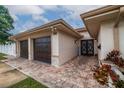 House exterior featuring a double-door entry and two-car garage at 2790 Pinellas Point S Dr, St Petersburg, FL 33712