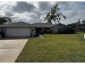 Single story home with attached garage and well-maintained lawn at 3922 Lake Joyce Dr, Land O Lakes, FL 34639