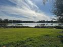 Scenic lakefront property with lush green grass at 3922 Lake Joyce Dr, Land O Lakes, FL 34639