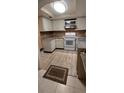 Bright kitchen featuring updated appliances and wood-look flooring at 515 Cottage Ln, Brandon, FL 33510