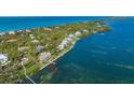 Bird's-eye view of waterfront property and surrounding neighborhood at 6119 Gnarled Oak Ln, Englewood, FL 34223