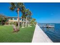 Relaxing waterfront view with a home and dock visible at 6119 Gnarled Oak Ln, Englewood, FL 34223