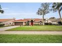 House exterior showcasing a well-maintained lawn and driveway at 161 Woodcreek N Dr, Safety Harbor, FL 34695