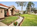 Landscaped walkway leading to a charming home's entrance at 161 Woodcreek N Dr, Safety Harbor, FL 34695