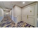 Clean condo hallway with carpet and neutral color palette at 6 Belleview Blvd # 105, Belleair, FL 33756