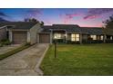 Attractive exterior of home at dusk with a manicured lawn at 9404 Rockbridge Cir # 9404, New Port Richey, FL 34655