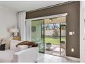 Living room with sliding glass doors to backyard at 17554 Holly Well Ave, Wimauma, FL 33598