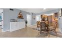 Bright dining area with a glass table and wicker chairs at 3806 Gulf Of Mexico Dr # C211, Longboat Key, FL 34228