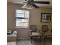 Living room with two armchairs and window at 122 Loblolly Ct # H, Oldsmar, FL 34677