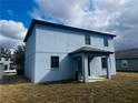 Side view of a two-story light blue house with backyard at 19820 Lonesome Pine Dr, Land O Lakes, FL 34638