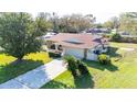 Charming single-story home with stone accents, a two-car garage, and a well-manicured lawn at 22368 Southshore Dr, Land O Lakes, FL 34639