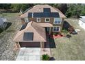 Aerial view of the two story home showcasing the roof and solar panels at 2359 Gimlet Ave, Spring Hill, FL 34608